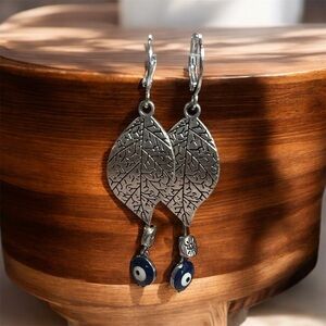 BOUTIQUE Silver Leaf Earrings with Blue Evil Eye Accents, Classy Dangles